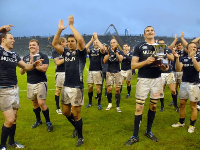 Captain Al Kellock holds the silverware as Scotland celebrate their Test series triumph over Argentina in 2010 after winning the second match in Mar del Plata. Picture: STR/AFP via Getty Images