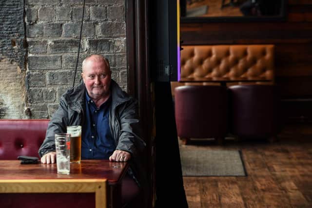 A customer sits with his beer in Jackson's Bar in the city centre of Glasgow on October 8, 2020. Photo by ANDY BUCHANAN/AFP via Getty Images