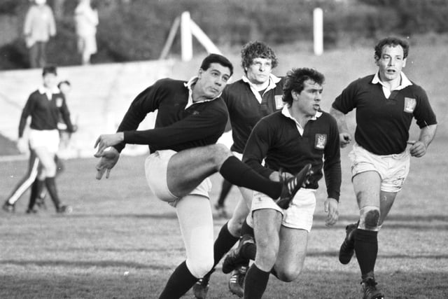 Scott Hastings kicks the ball  (David Milne at extreme right) during the Edinburgh v Anglo-Scots rugby match in December 1986. Final score 17-10 to Edinburgh.