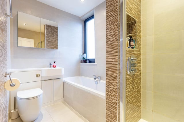 The modern ground floor family bathroom with bath and separate walk-in rain shower.