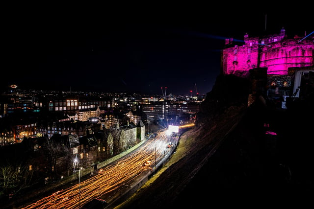 The Torchlight Procession pictured on Friday making its way past Edinburgh Castle, with a new route for the event's welcome returning taking participants through the city's Old Town.