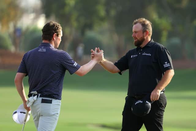 Bob MacIntyre shakes hands with playing partner Shane Lowry at Jumeirah Golf Estates. Picture: Andrew Redington/Getty Images.