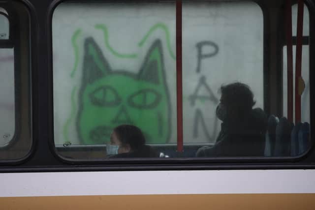 Two people sit on a bus in Edinburgh where stricter lockdown measures for mainland Scotland are now in force. Picture: Andrew Milligan/PA Wire