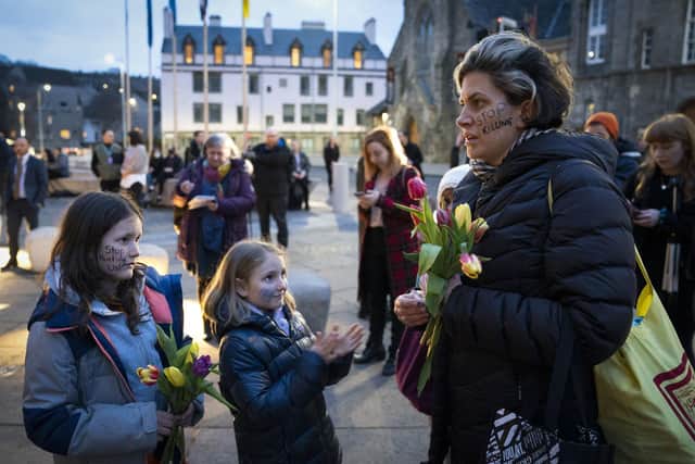 People take part in a memorial protest outside the Scottish Parliament in Edinburgh to mark the anniversary of the murder of Sarah Everard and other women killed by men (Photo: Jane Barlow/PA Wire).