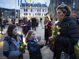 People take part in a memorial protest outside the Scottish Parliament in Edinburgh to mark the anniversary of the murder of Sarah Everard and other women killed by men (Photo: Jane Barlow/PA Wire).