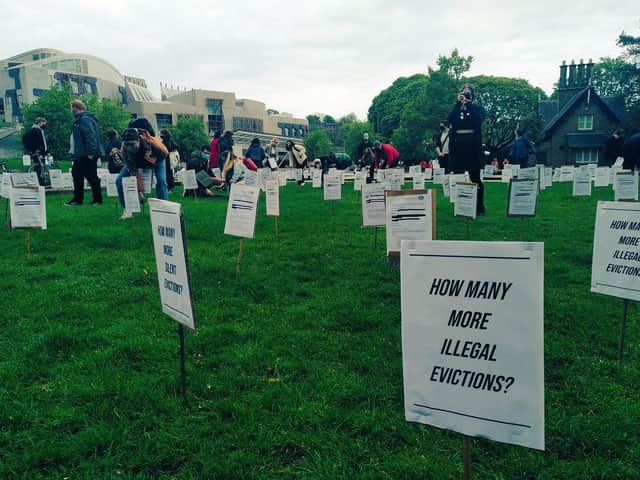 Eviction orders planted in the ground by Living Rent members as part of their protest at Holyrood yesterday.