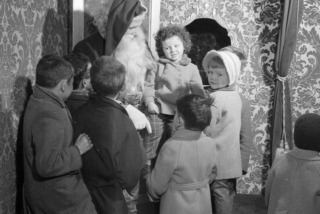 Children crowded around Santa, keen to tell him what they wanted for Christmas, in an Edinburgh store.