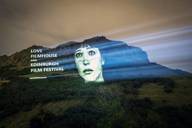 An image of actor Anna Karina from the film Vivre Sa Vie projected on Salisbury Crags in Edinburgh, is one of several classic movie images projected onto landmarks and public buildings in the city as part of the campaign to save the Edinburgh International Film Festival and the Filmhouse.