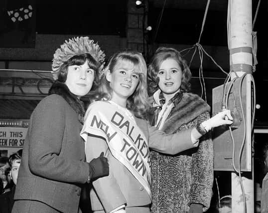 Dalkeith's New Town Girl, 18-year-old Joan Hepburn, switches on the Christmas Lights alongside runners-up Ruth Wysick and Teresa O'Brien in 1964.