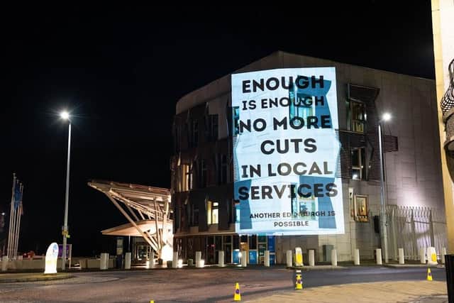 The campaigners' protest appeared in lights on the Scottish Parliament