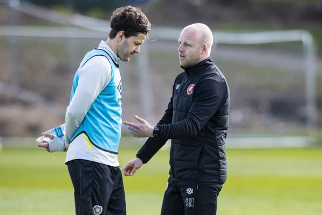 Steven Naismith and Peter Haring deep in discussion at Hearts training on Thursday.