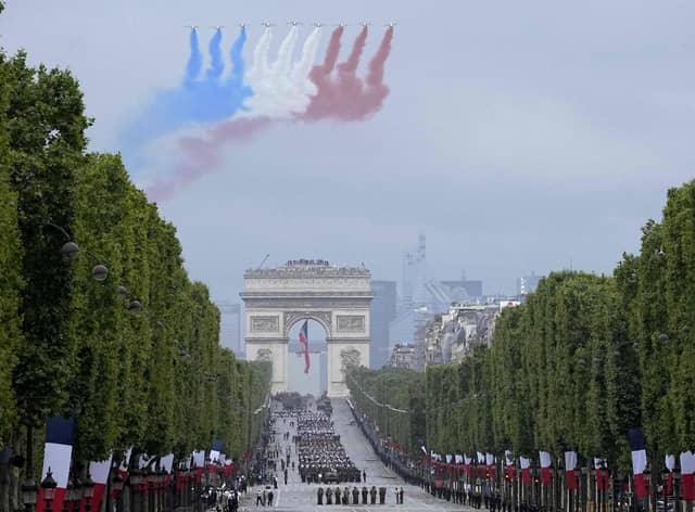 Alphajet aircraft fly over L'Arc de Triomphe during the annual Bastille Day military parade on the Champs-Elysees avenue in Paris on 14 July 2021 (Getty Images)