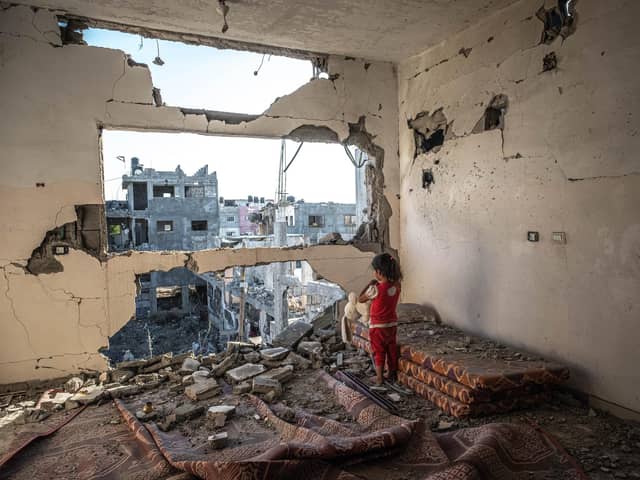 A Palestinian girl stands amid the rubble of her destroyed home in Beit Hanoun, Gaza, in May 2021 (Picture: Fatima Shbair/Getty Images)