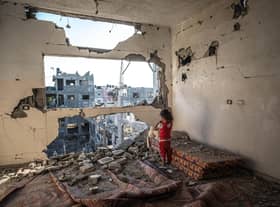 A Palestinian girl stands amid the rubble of her destroyed home in Beit Hanoun, Gaza, in May 2021 (Picture: Fatima Shbair/Getty Images)