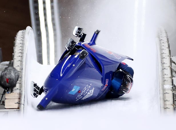 Brad Hall and Nick Gleeson of Team Great Britain crash during the two-man bobsleigh at the 2022 Winter Olympic Games