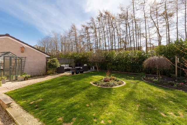 There is a small area of walled front garden and a large, sunny south facing landscaped rear garden bounded by trees, with patio for dining and another for lounging, lawn with feature beds, borders and garden shed.