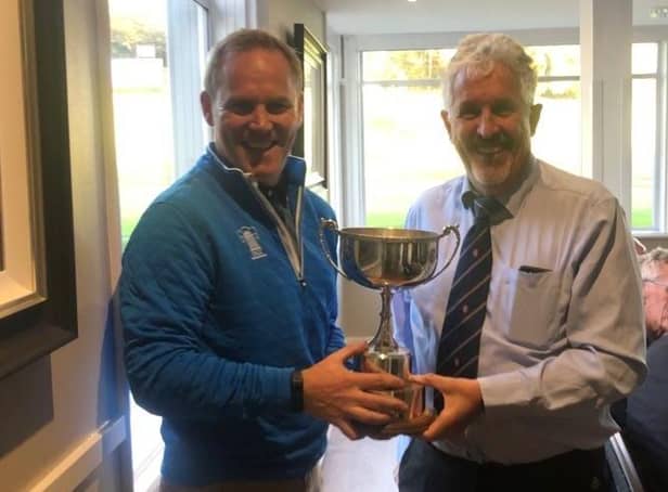 Duddingston team captain David Miller, left, receiving the Inter Cities Trophy from tournament organiser Ian McDonald