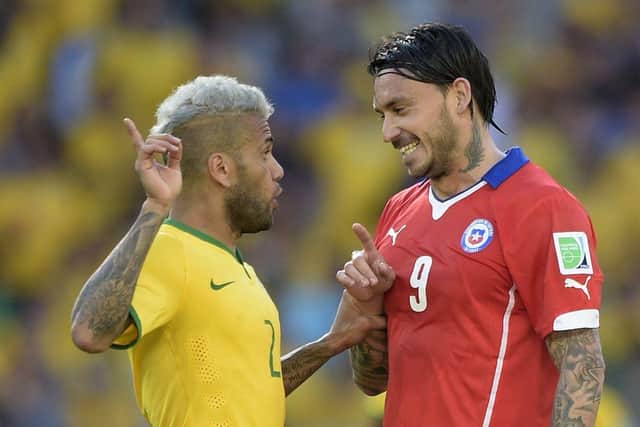 Mauricio Pinilla in discussion with Dani Alves at the 2014 World Cup. Picture: Getty