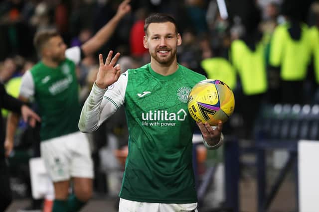 Hat-trick hero: Hibs' Martin Boyle celebrates with the match ball after his treble against Rangers