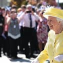 Schools in Scotland are expected to be closed during a public holiday on the day of the Queen's funeral. Pictured is the Queen on a visit to Greenfaulds High School in Cumbernauld (Photo: John Devlin).