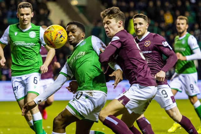 Stephane Omeonga and Aaron Hickey in action during the Ladbrokes Premiership match between Hibs and Hearts at Easter Road on March 03, 2020. (Photo by Ross Parker / SNS Group)