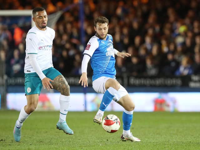 Jorge Grant in action for Peterborough against Manchester City's Gabriel Jesus