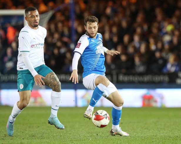 Jorge Grant in action for Peterborough against Manchester City's Gabriel Jesus