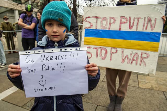 A child carrying a sign which reads "Go Ukraine, stop Putin. I love Ukraine." (Picture credit: Lisa Ferguson)