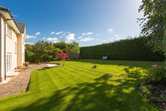 The front and back gardens are beautifully landscaped, providing space for outdoor activities, gardening, or just enjoying the scenery.  This garden provides a perfect setting for al fresco dining, gardening, or simply enjoying the sun.