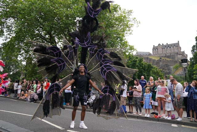 In a crowd of brightly-coloured costumes, this dancer caught onlookers eyes with his impressive black and purple ensemble.