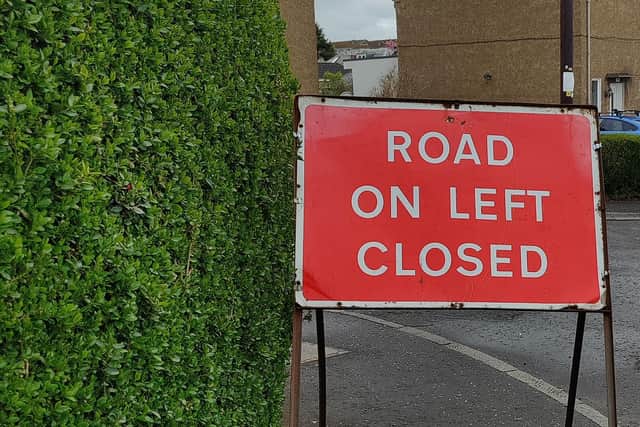 The signs block pedestrian access and have forced pupils to walk on the busy road.