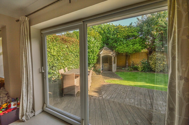 There are sliding patio doors leading from the sitting room to the rear garden.