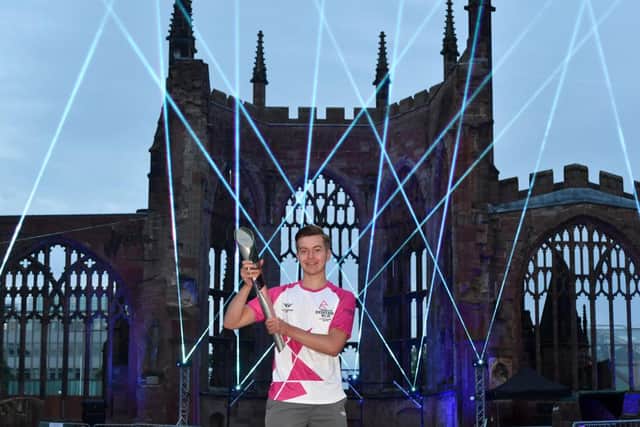Baton bearer Mikey Akers carries the Queen's Baton during the Birmingham 2022 Queen's Baton Relay at Coventry Cathedral on July 21, 2022.