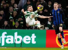 Celtic's Anthony Ralston with an acrobatic attempt on goal as Hearts defender Kye Rowles looks on.