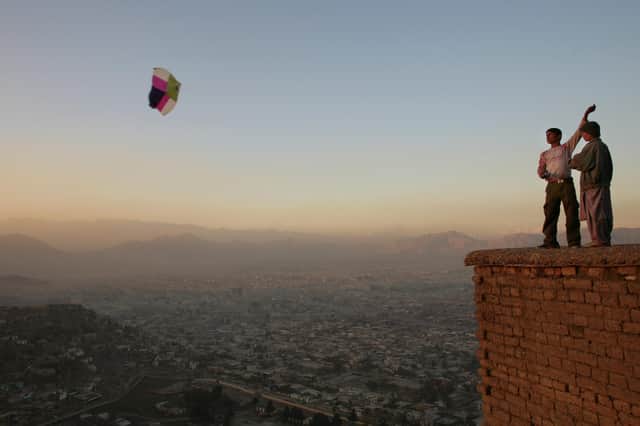 Boys fly a kite on a hill overlooking Kabul (Picture: Paula Bronstein/Getty Images)