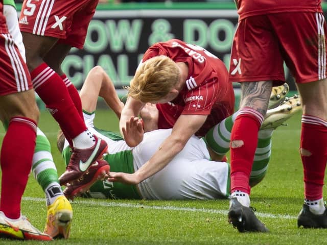 Ryan Porteous and Aberdeen's Liam Scales  hit the turf, which results in a penalty for Hibs