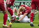 Ryan Porteous and Aberdeen's Liam Scales  hit the turf, which results in a penalty for Hibs