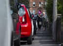 Pedestrians struggling to get past cars parked on an Edinburgh pavement. Picture: Lisa Ferguson