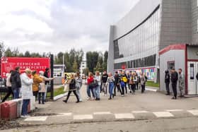 Students evacuate a building of the Perm university campus