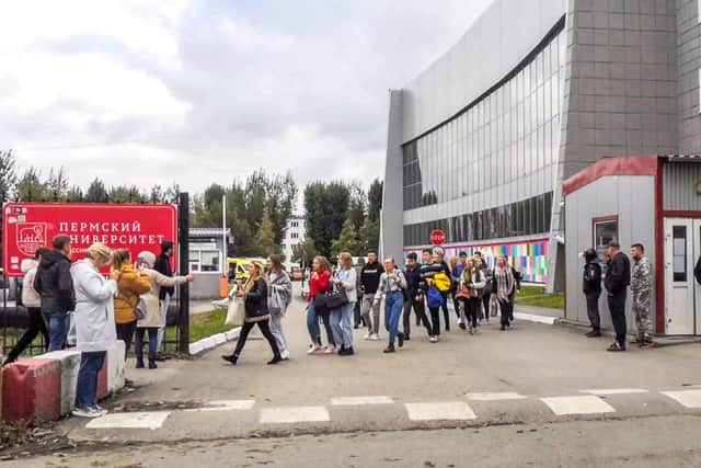 Students evacuate a building of the Perm university campus