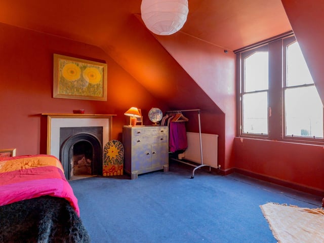 Yet another good-sized double bedroom on the upper level, with the addition of a traditional fireplace.