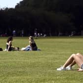 Someone sunbathing on The Meadows in Edinburgh - The Capital is expected to see temperatures rise into the high teens this afternoon.