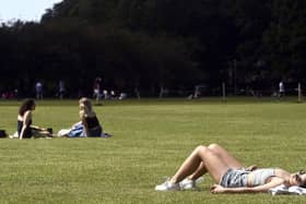 Someone sunbathing on The Meadows in Edinburgh - The Capital is expected to see temperatures rise into the high teens this afternoon.