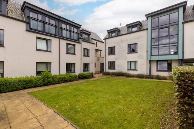 The apartment features access to this shared well-maintained garden space.