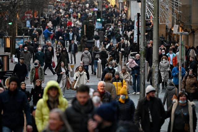 Christmas shoppers in Glasgow as shoppers are being warned that scam delivery text messages are on the increase in the run up to Christmas (Photo by Jeff J Mitchell/Getty Images).