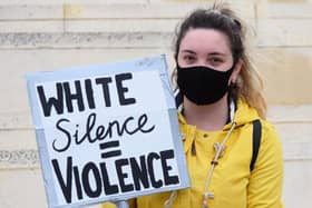 Peggy McIntosh who popularised the term, wrote "I was taught to see racism only in individual acts of meanness, not in invisible systems conferring dominance on my group." Pictured: A young protester at a Black Lives Matter protest in Swindon.