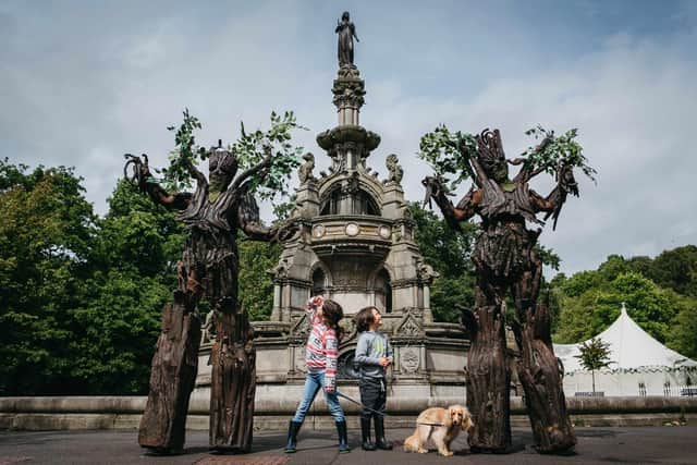 Clem Sheridan (8) and Sholto Sheridan (6) met 'The Tree Men' at the Dandelion Festival in Glasgow's Kelvingrove Park at the weekend (Picture: Andrew Cawley)