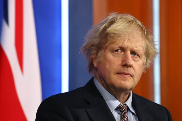 Boris Johnson's government introduced higher rates of National Insurance, paid by everyone, to avoid increasing taxes on the wealthiest (Picture: Hollie Adams/WPA pool/Getty Images)