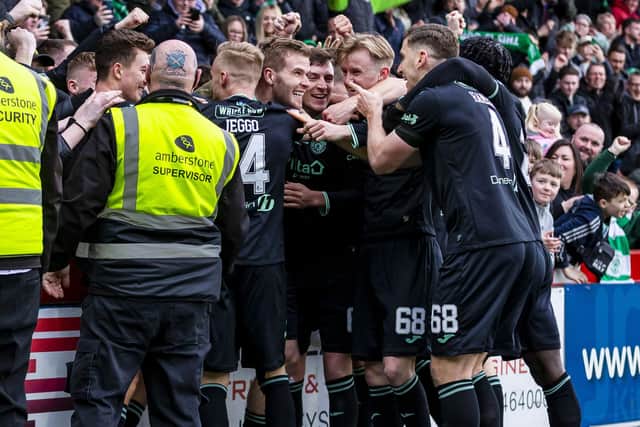 The Hibs players celebrate the third goal against Livingston
