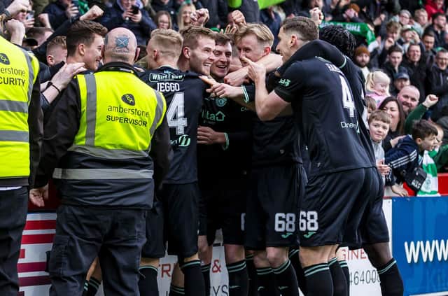 The Hibs players celebrate the third goal against Livingston